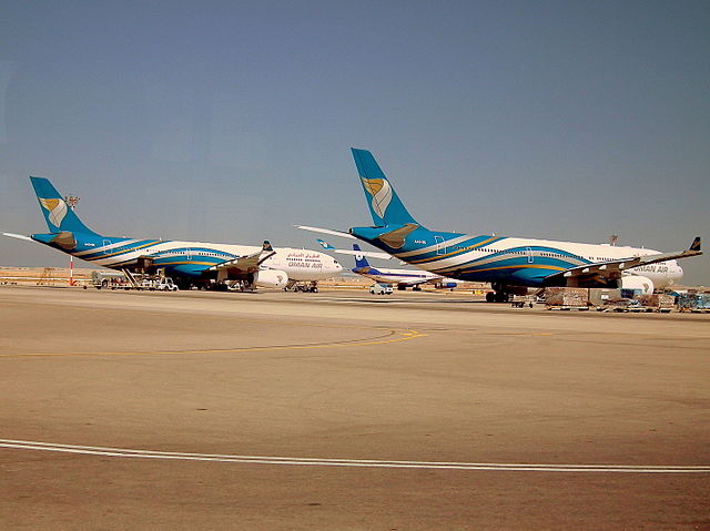 Oman Air Airbus A330-300s parked on the apron of the old terminal. Until the opening of the new terminal, there were no jetbridges available.