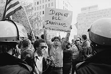 An anti-Iranian protest in Washington, D.C., in 1979. The front of the sign reads "Deport all Iranians" and "Get the hell out of my country", and the back reads "Release all Americans now". Man holding sign during Iranian hostage crisis protest, 1979.jpg