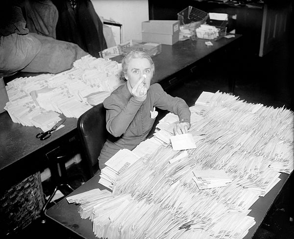 FDR's personal secretary Missy LeHand with 30,000 letters containing ten-cent contributions to the National Foundation for Infantile Paralysis that ar