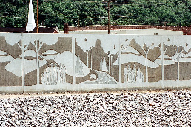 A section of the flood wall along the Tug Fork in Matewan, West Virginia, constructed by the U.S. Army Corps of Engineers, depicts the Hatfield–McCoy 
