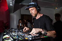 Like disco, house music was based around DJs creating mixes for dancers in clubs. Pictured is DJ Miguel Migs, mixing using CDJ players. Miguel Migs by Peter Chiapperino.jpg
