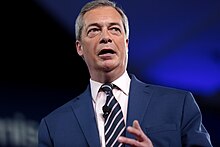 Nigel Farage, former leader of UKIP and the Brexit Party, presents a prime-time show on GB News Nigel Farage (33149372715).jpg