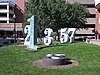 Several tall Arabic numerals standing upright in a lawn.