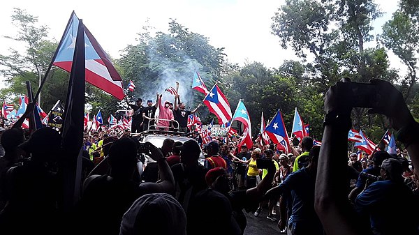 Protesters celebrating the resignation of Ricardo Rosselló in San Juan, the day after the announcement. Residente, Bad Bunny and Ricky Martin (center,