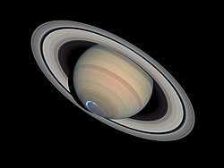 Photomontage of Saturn with a false-colour image of ultraviolet aurora (january 2004)