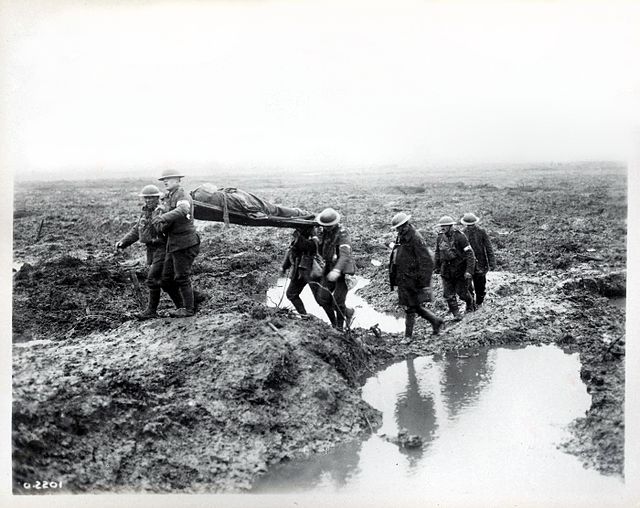Troops during the Battle of Passchendaele carry a wounded man to the aid post. The terrain pictured and the battle exemplified much of the fighting of