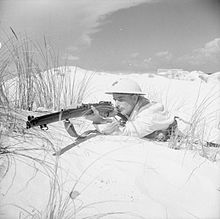 A rifleman of the 1st Battalion, South Staffordshire Regiment wearing a light-coloured oversuit for camouflage against the dunes during training at Mersa Matruh, 25 October 1940. The British Army in North Africa E846.jpg