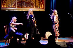 The Gothard Sisters performing during a concert in 2018 The Gothard Sisters in 2018 performing indoors with their musical instruments, some of which are behind them.jpg