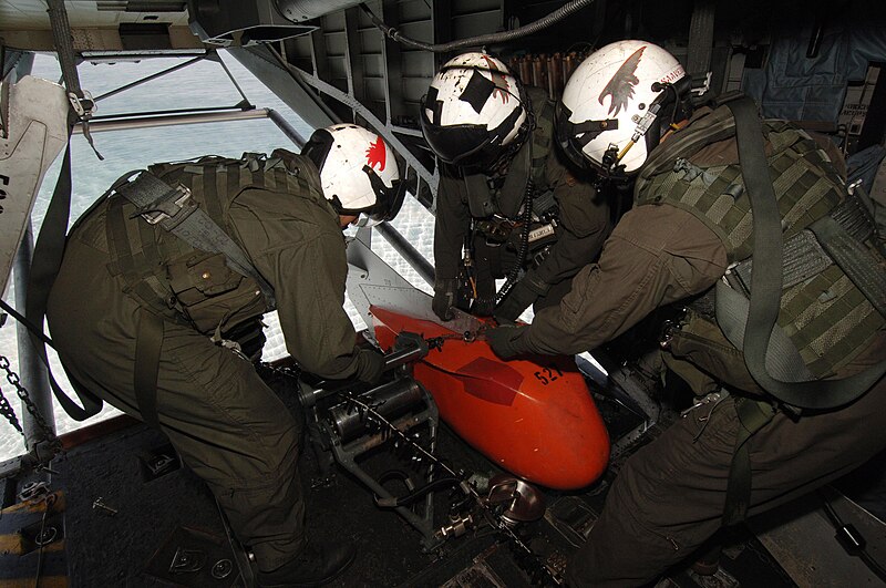 File:US Navy 060315-N-4374S-012 An air crewman assigned to the Blackhawks of Helicopter Mine Counter Measure Squadron One Five (HM-15), retrieves a marker float from the rear ramp of an MH-53E Sea Dragon helicopter during an MK-103.jpg