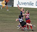 Melbourne University player jostles for best position in a marking contest.