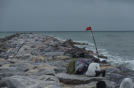 Young-people-sitting-on-wave-breaker-at-elegushi-beach.jpg