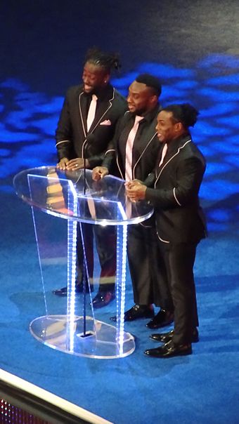 Kingston, Big E and Woods inducting The Fabulous Freebirds into the WWE Hall of Fame in April 2016