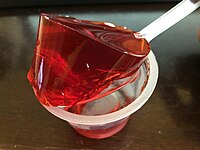 2019-10-10 22 15 43 Gelatin from a single opened cup of Jell-O strawberry gelatin snack being lifted by a spoon in the Franklin Farm section of Oak Hill, Fairfax County, Virginia.jpg