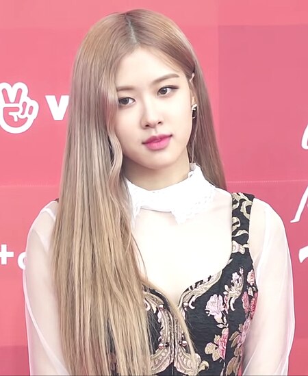Rosé seen from the shoulders up, looks forward, slightly away from the camera.