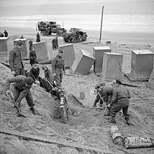 Engineers of the 1st Rifle Brigade (1st Polish Corps) constructing beach defences at Tentsmuir in Scotland. The concrete blocks were used as anti-tank obstacles. Allied Forces in the United Kingdom 1939-45 H5493.jpg