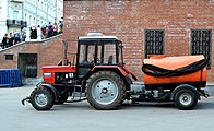 A MTZ-82.1 tractor with street sprinkling equipment and a towed water tank. A side view. 2014.