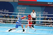 Deutsch: Boxen bei den Olympischen Jugendspielen 2018 Tag 12, 18. Oktober 2018 - Kampf um Bronze im Leichten Weltergewicht Jungen – Hassan Azim (Großbritannien, rot) schlägt Mohammed Boulaouja (Marokko, blau) RSC; Ringrichter ist Wulfren Olivares Peréz (Kolumbien). English: Boxing at the 2018 Summer Youth Olympics on 18 October 2018 – Bronze Medail Match Light Welterweight Boys - Hassan Azim (Great Britain, red) beats Mohammed Boulaouja (Morocco, blue) RSC; Referee is Wulfren Olivares Peréz (Columbia). Español: Boxeo en los Juegos Olímpicos Juveniles de Verano de 2018 en 18 de octubre de 2018 - Medalla de bronce de los hombres ligeros de peso welter: Hassan Azim (Gran Bretaña, rojo) vence a Mohammed Boulaouja (Marruecos, azul) RSC; El árbitro es Wulfren Olivares Peréz (Colombia).