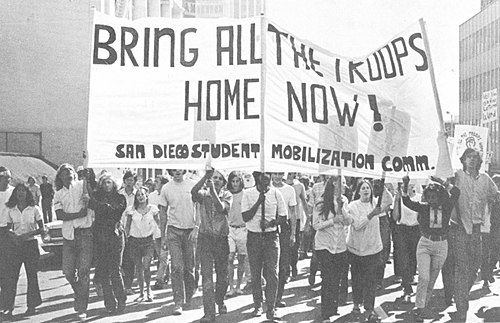 University of San Diego students holding sign saying "bring all the troops home now!".