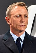 A head shot of a light-haired man in a suit