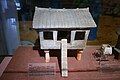 An Eastern-Han pottery granero with tiled roof, stilt supports, and a doorway approached by a plank