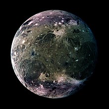 Enhanced-color Galileo spacecraft image of Ganymede's trailing hemisphere. The crater Tashmetum's prominent rays are at lower right, and the large ejecta field of Hershef at upper right. Part of dark Nicholson Regio is at lower left, bounded on its upper right by Harpagia Sulcus. Ganymede-moon.jpg