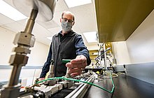 Greg Glatzmaier, at the National Renewable Energy Laboratory, determines the high-temperature thermal and mechanical stability of sealants used in a lab prototype of the integrated hydrogen sensor separator module. Greg Glatzmaier determines the high-temperature thermal and mechanical stability of sealants used in a lab prototype of the integrated hydrogen sensor separator module.jpg