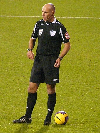 Referee Howard Webb wearing a black strip
