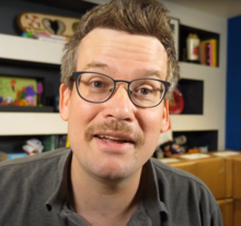 John Green sporting a mustache during "Pizzamas" in 2020 John Green without Pizza John.png