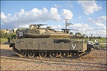 A profile of a Merkava Mk 4M tank, armed with an IMI 120 mm gun, a M2 Browning .50-cal, a 7.62×51 mm NATO commander's FN MAG, and equipped with the Trophy active protection system.