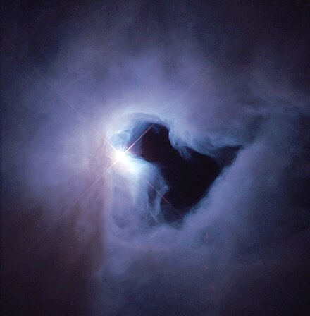 The reflection nebula NGC 1999 is brilliantly illuminated by V380 Orionis. The black patch of sky is a vast hole of empty space and not a dark nebula as previously thought.