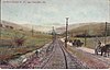 Northern Electric Railway line next to a dirt road with horse-drawn wagons in 1908