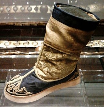called Shoe of Queen Marysieńka in the District Museum in Tarnów is an example of late 17th-century Qing dynasty shoemaking.[3] The damask and satin body was mounted on cardboard sole.[3]