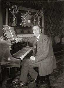 Rachmaninoff seated at a Steinway grand piano