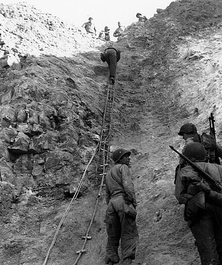 2nd Ranger Battalion troops use rope ladders to scale Pointe du Hoc.