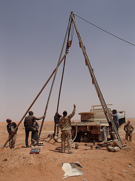 Members of the Syrian Free Army and a US Army soldier repair a water well in Al-Tanf.