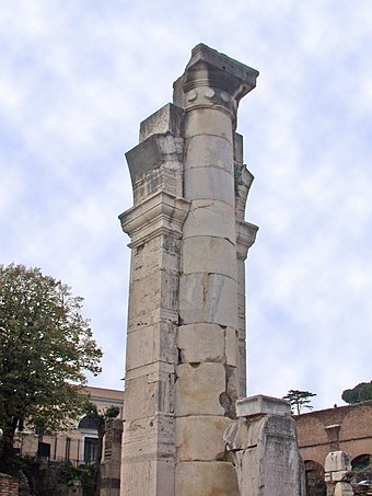 The reconstructed remains of a center column with support. The flaring at the top is the beginning of arches for the bottom tier