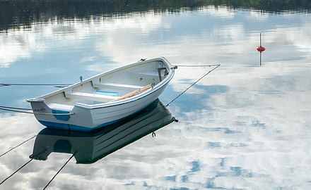 Rowing boat resting on cloud reflections at Rågårdsdal