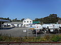 Typical LIRR Helvetica sign, and a heating oil station behind it.