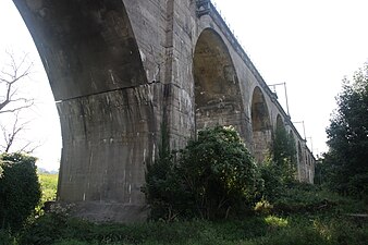 Het spoorwegviaduct met links de scharnierboog