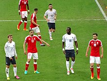 Sissoko (wearing white; No.18) playing for France against Switzerland at UEFA EURO 2016; France would finish the tournament as runners-up. Suisse - France 2016.jpg