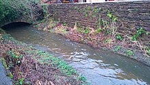 Thacka Beck emerging from its culvert behind the Tourist information centre