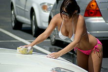 A waitress at Twin Peaks washes a customer's car (Austin, 2012). Twin Peaks Austin Bikini Car Wash Jul 2012.jpg