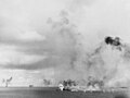 USS Smith (DD-378) is hit by a crashing Japanese torpedo plane, during an attack on USS Enterprise, 26 October 1942. Photographed from USS South Dakota.