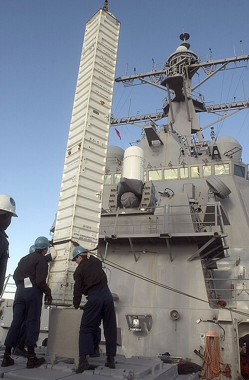 A Tomahawk missile canister being offloaded from a VLS aboard the Arleigh Burke-class destroyer USS Curtis Wilbur