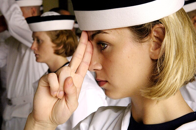 File:US Navy 070627-N-9241M-130 Ashley Bucholz is taught how to properly wear her cover. The cover should rest two fingers above the top of her nose.jpg