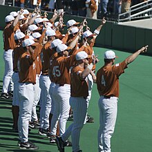 The Longhorn baseball team gives the Hook 'em Horns sign after a game. UTbaseball.jpg