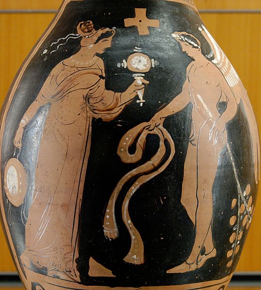 Winged genius facing a woman with a tambourine and mirror, from southern Italy, about 320 BC