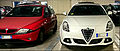 " 15 - ITALY - sportbacks cars Lancia Y red and Alfa Romeo Giulietta white front view.jpg