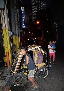 This girl works as a child labourer until late at night, Manila, Philippines