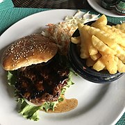 A plate of fries and a beef burger with salad.jpg